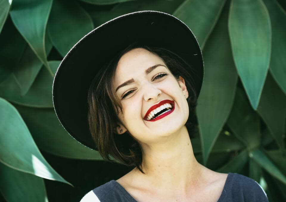 image of a smiling woman with a hat