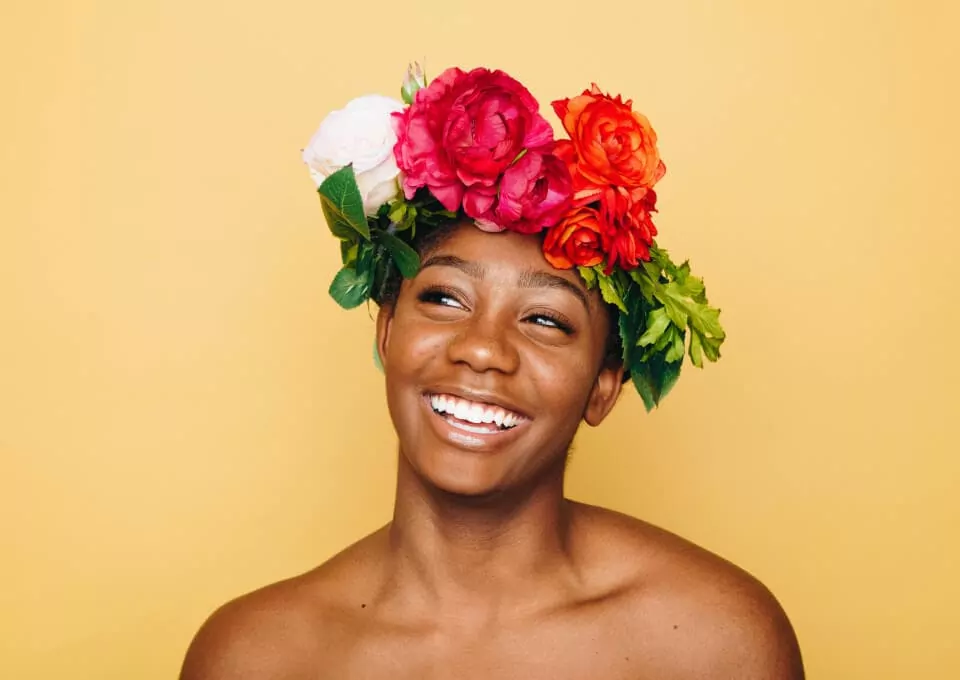image of a smiling woman with flowers in her hair
